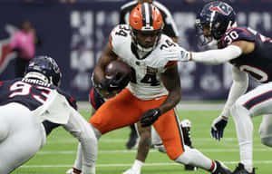 Football Player Evading Tackle Wallpaper