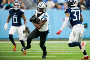 Football Player Evading Tackle During Game Wallpaper