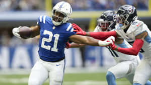 Football Player Evading Tackle Wallpaper