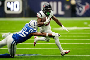 Football Player Evading Tackle Wallpaper