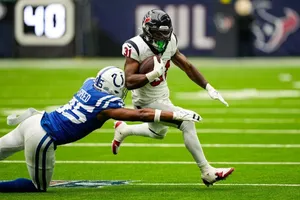 Football Player Evading Tackle Wallpaper