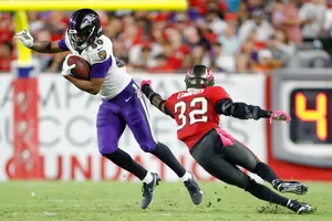 Football Player Evading Tackle Wallpaper