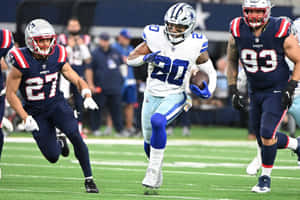 Football Player Evading Tackles During Game Wallpaper