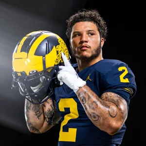 Football Player Holding Helmet Portrait Wallpaper