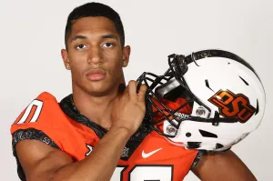 Football Player Holding Helmet Wallpaper