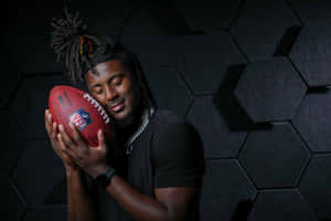 Football_ Player_ Holding_ N F L_ Ball Wallpaper