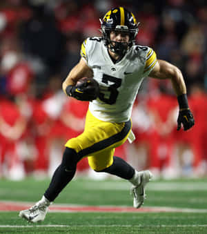 Football Player In Action During Game Wallpaper