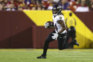 Football Player In Action During Game Wallpaper