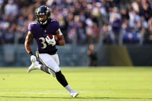 Football Player In Action During Game.jpg Wallpaper