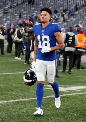 Football Player Isaiah Hodgins Walking Off Field Wallpaper