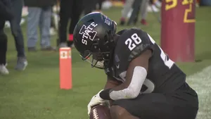 Football Player Kneelingwith Ball Wallpaper