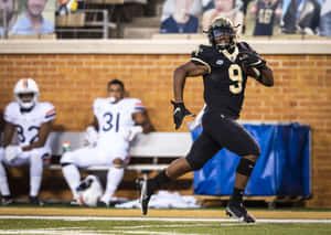 Football_ Player_ Number_9_ Running_ Action_ Shot Wallpaper