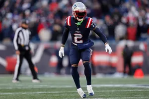 Football Player On Field Action Wallpaper