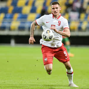 Football Player Patryk Klimala Running Wallpaper