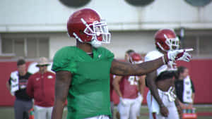 Football Player Pointing During Practice Wallpaper