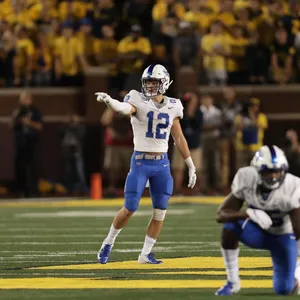 Football Player Pointing On Field Wallpaper