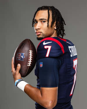 Football Player Portrait Holding Ball Wallpaper