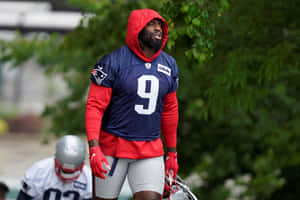 Football Player Rainy Practice Session Wallpaper