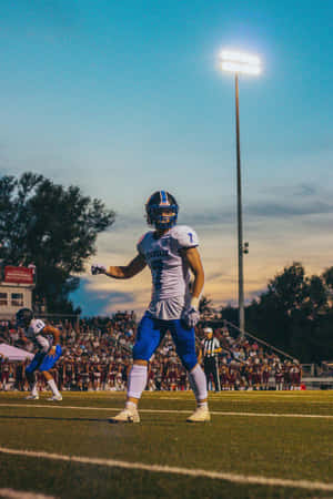 Football Player Ready At Dusk Wallpaper