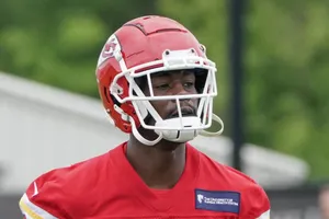 Football Player Red Helmet Practice Session Wallpaper