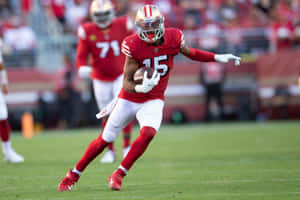 Football Player Running With Ball During Game Wallpaper