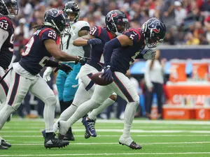Football Player Running With Ball During Game Wallpaper