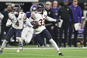 Football Player Running With Ball During Game Wallpaper