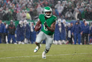 Football Player Runningin Rain Game Action Wallpaper