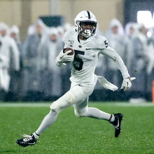 Football Player Runningin Rain Wallpaper