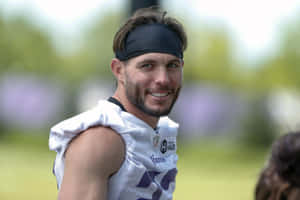 Football Player Smiling During Practice Wallpaper