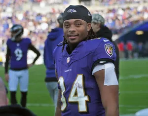 Football Player Smiling On Field Wallpaper