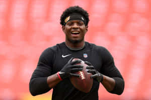 Football Player Smiling With Ball Wallpaper