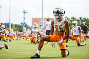 Football Player Stretching During Practice Wallpaper