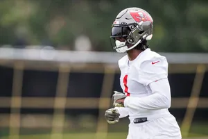 Football Player Training Outdoors Wallpaper