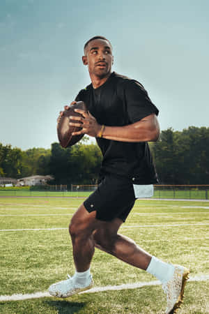 Football Player Training Outdoors Wallpaper