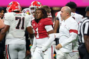 Football Player Walkingwith Coach Wallpaper