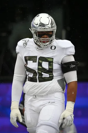 Football Playerin Action Rainy Game Wallpaper