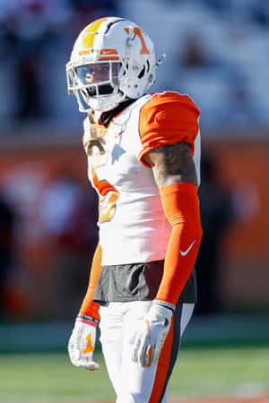 Football Playerin Orangeand White Uniform Wallpaper