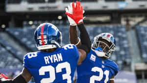 Football Players Celebrating On Field Wallpaper