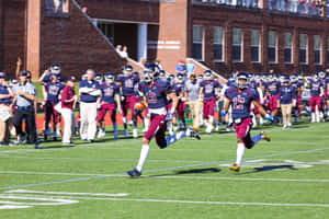 Football Players Celebrating Victoryon Field.jpg Wallpaper