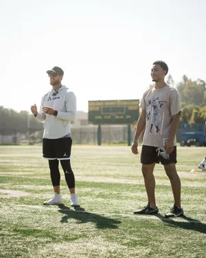 Football Players On Field During Sunny Day Wallpaper