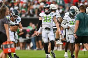 Football Players Walkingon Field Wallpaper