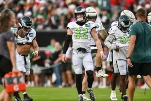 Football Players Walkingon Field Wallpaper