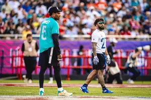 Football Players Walkingon Field Wallpaper