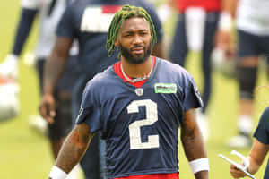 Football Playerwith Green Hair During Training Wallpaper