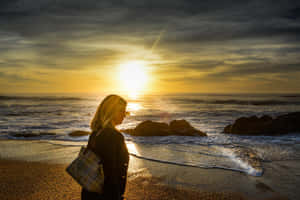 Footsteps On A Serene Beach Walk Wallpaper