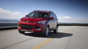Ford Escape On A Picturesque Mountain Road Wallpaper
