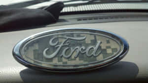 Ford Logo Shining Bright On A Black Background Wallpaper