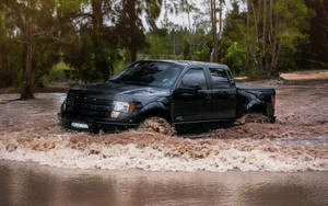 Ford Raptor Crossing A Muddy Flood Wallpaper