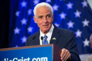 Former Florida Governor Charlie Crist Holding A Podium Wallpaper